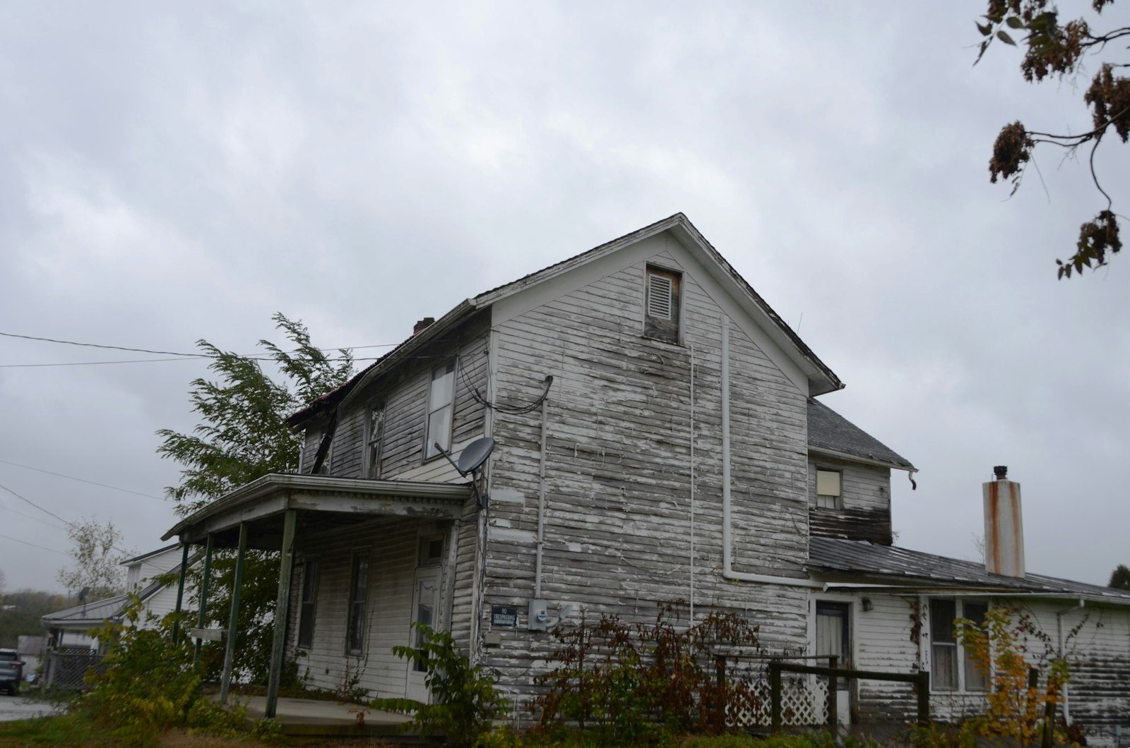 Home exterior needing repairs and deferred maintenance